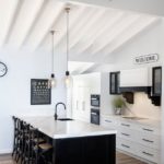 Modern Wooden Kitchen with white stone benchtops and splashback— Stoneworks in NSW