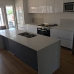 Modern kitchen with stone island benchtop — Stoneworks in NSW