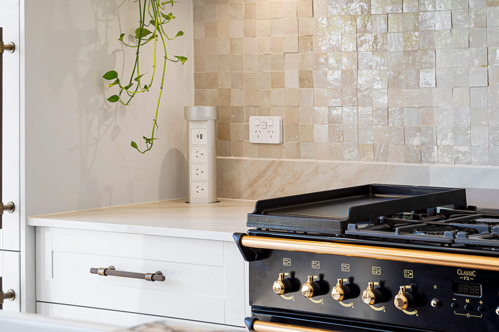 A Kitchen Featuring a Stone Benchtops and a Plant on the Counter — Vivid Stoneworks in Thornton, NSW