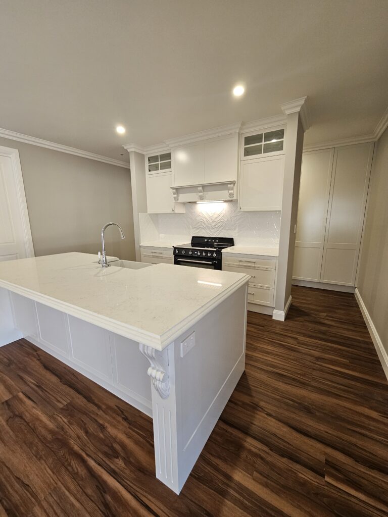 background image of a white kitchen with white stone benchtops - Newcastle, NSW