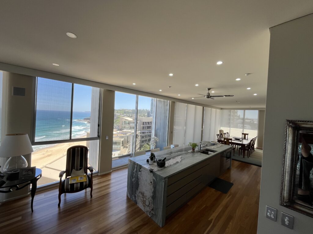 background image of a white kitchen with white stone benchtops - Newcastle, NSW