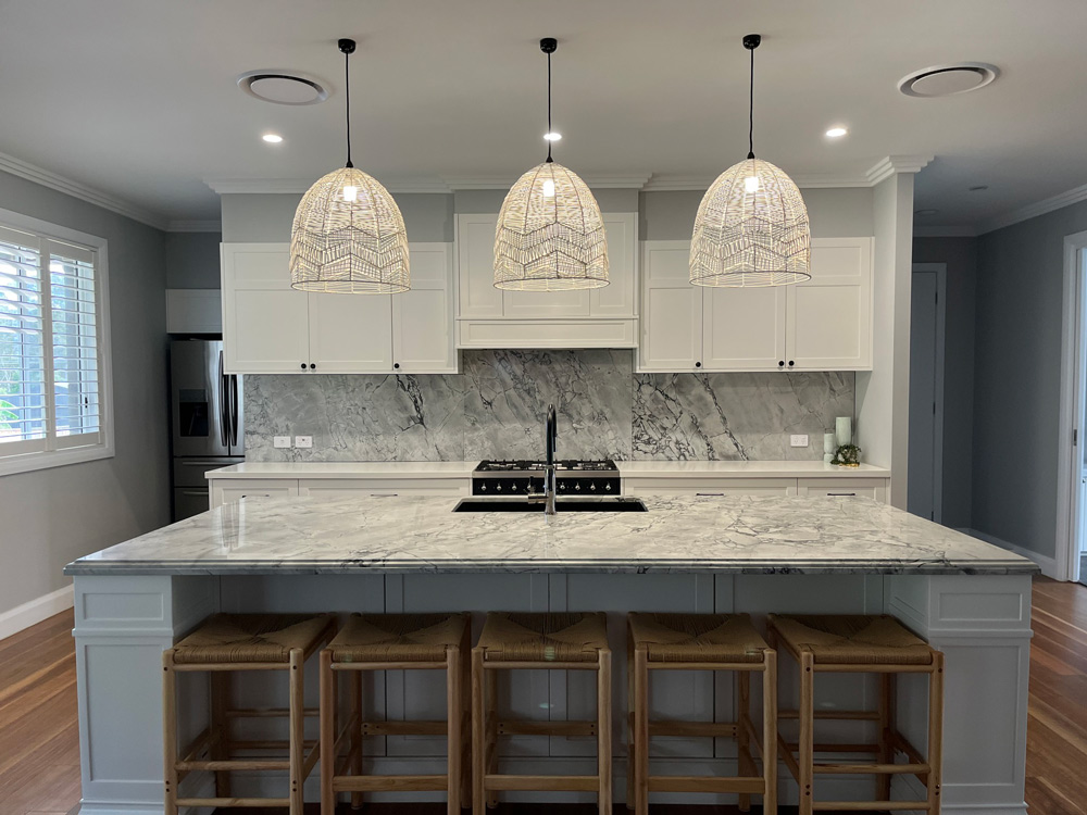 Kitchen with White Cabinets and Granite Benchtop