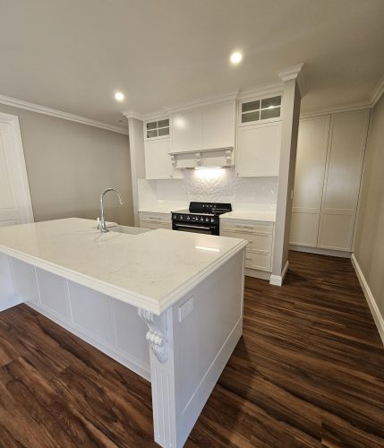background image of a white kitchen with white stone benchtops - Newcastle, NSW