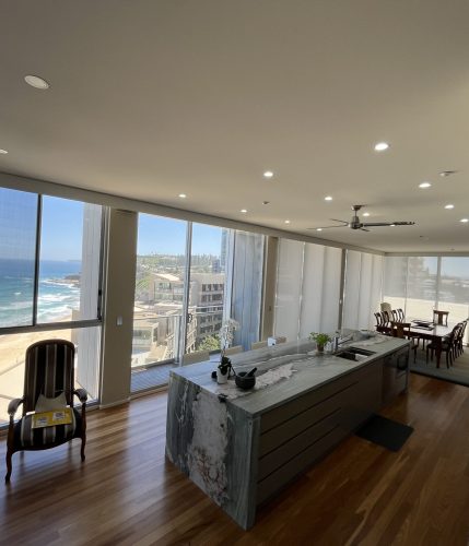 background image of a white kitchen with white stone benchtops - Newcastle, NSW