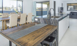 Stone island countertop integrated into modern kitchen design in Newcastle